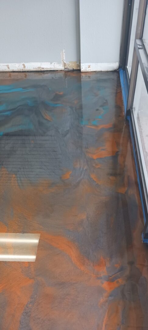 A floor with some rust on it and the floor is painted blue